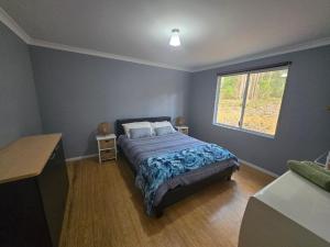 a bedroom with a bed and a window at 75 Peace Street in Denmark