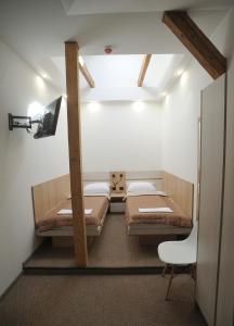 a room with two bunk beds and a tv at Віенер in Stryi