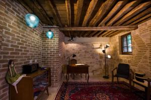 a room with a brick wall and a desk and a chair at Riverside - Eco Living in Veria