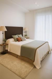 Giường trong phòng chung tại Les DEVESES DENIA GRUPOBLAZQUEZ