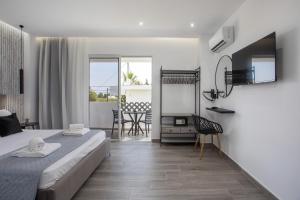 a bedroom with a bed and a dining room at Vickys Rooms - Faliraki in Faliraki