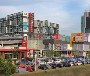 a parking lot with cars parked in front of buildings at Hm home in Sepang