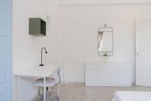 a white office with a desk and a chair at Stadium Residence in Brescia
