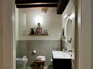 a bathroom with a sink and a toilet at Roma284 Apt Centro in Piacenza +12 photos