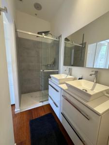a bathroom with two sinks and a shower at AC-Free Parking - Contemporary 4 Bedroom Villa Apartment in Cannes