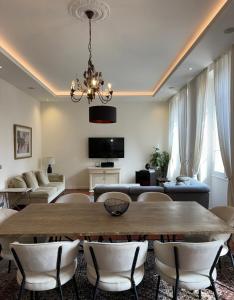 a large living room with a table and chairs at AC-Free Parking - Contemporary 4 Bedroom Villa Apartment in Cannes