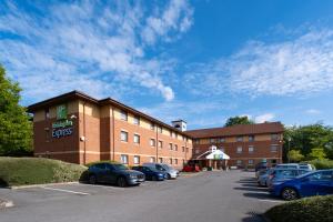 a hotel with cars parked in a parking lot at Holiday Inn Express Taunton East by IHG in Taunton +74 photos