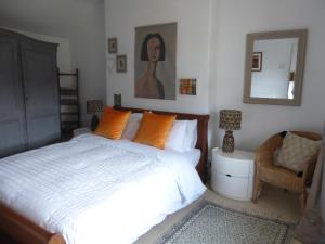a bedroom with a bed and a mirror and a chair at 8 Willow Street in Llanrwst