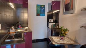 a small kitchen with a sink and a counter at Moderne Ferienwohnung mit privatem Balkon sowie Meer- und Gebirgsblick in Icod de los Vinos