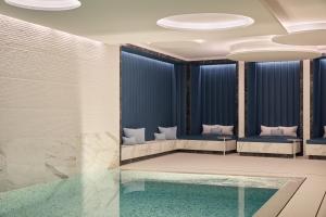a room with a swimming pool with blue walls and ceilings at The Woodward - Auberge Resorts Collection in Geneva