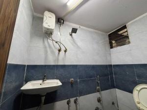 a bathroom with a sink and a toilet at Hotel O Heritage Inn in Mehsāna
