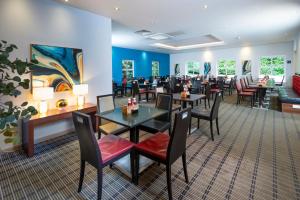 a dining room with tables and chairs in a restaurant at Holiday Inn Express Taunton East by IHG in Taunton
