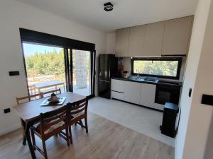 a kitchen and dining room with a table and chairs at Maginja in Petrovac na Moru