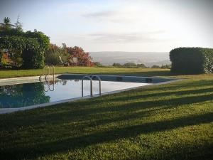 a swimming pool in the middle of a grass field at Monte CHORA CASCAS in Montemor-o-Novo