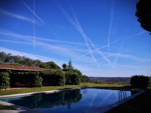 a swimming pool in front of a house at Monte CHORA CASCAS in Montemor-o-Novo