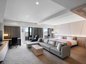 a living room with a couch and a bed at Daiwa Roynet Hotel Sendai Ichibancho PREMIER in Sendai