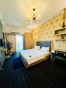 a bedroom with a large bed and a television at Dream Vibes the Cosy Stay in Noida