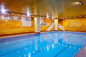 a swimming pool with blue water in a building at Kabul Taj Hotel in Kabul