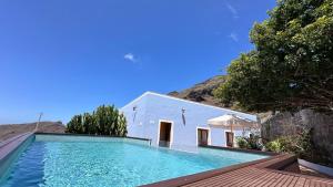a swimming pool in front of a white building at Casa Regina Tenerife in Tamaimo