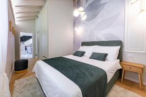 a bedroom with a large white bed with two pillows at Luxury villa Lia in Dubrovnik