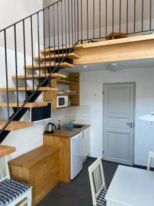 a kitchen with a staircase and a kitchen with a table at Mallas Stenstugu B&B in Visby