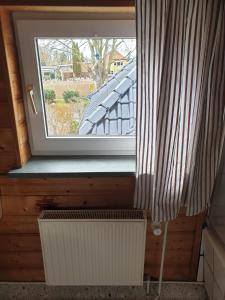 a window in a room with a radiator in front of it at Ruegen_Fewo 41 in Rambin