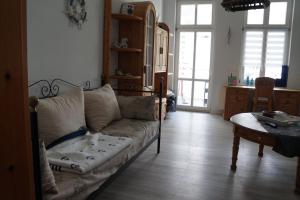 a living room with a couch and a table at Haus Quisisana - Fewo 1 - 4549 in Göhren