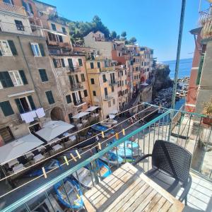 a balcony with a view of a pool and buildings at IL PORTICCIOLO in Riomaggiore