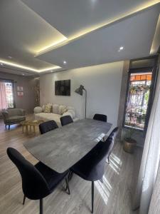 a dining room with a table and chairs and a couch at Lune Rouge Rooms in Marrakech