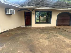 a house with a driveway in front of a garage at Empangeni guest house 2 in Empangeni +10 photos