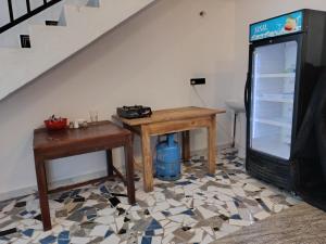 a living room with a table and a television at Elite Bay Arugambay in Arugam Bay