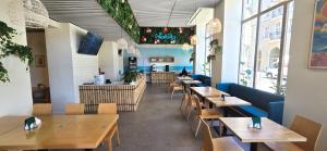 a restaurant with wooden tables and chairs and a counter at Hotel Piast Wrocław Centrum in Wrocław