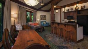a living room with a kitchen and a living room with a table at Disney's Saratoga Springs Resort & Spa in Orlando