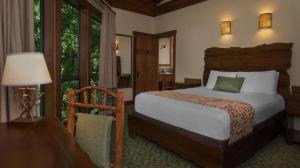 a bedroom with a bed and a table with a lamp at Disney's Saratoga Springs Resort & Spa in Orlando +110 photos