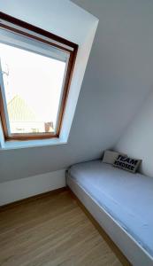 a small room with a bed and a window at Juist Ferienwohnung 304 Strandburg in Juist +2 photos