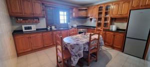 a kitchen with a table with chairs and a refrigerator at Villa Lucía in Tías