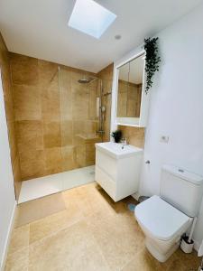 a bathroom with a toilet and a shower and a sink at Bungalow Mesana 27 in Playa Honda