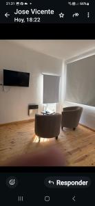 a picture of a living room with two chairs and a table at Acordes de Gaitas dpto3 in Malargüe