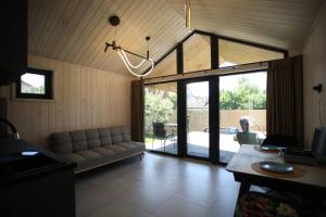 a living room with a couch and a sliding glass door at Ministerka House in Kyiv