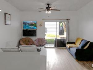 a living room with two couches and a ceiling fan at Garden Level 1BR condo, Central Luxury Suite in Wilmington