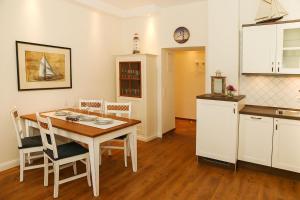 a kitchen and dining room with a table and chairs at Dünenschloss - 02-24 in Kühlungsborn