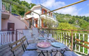 a patio with a table and chairs on a balcony at Amazing Apartment In Cervo With Wifi in Cervo