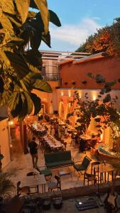 a patio with tables and chairs in a building at Empyrean Art Deco in Santo Domingo