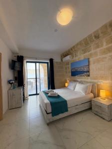 a bedroom with a large bed and a large window at Fiftyfour West Boutique Living in Għarb +96 photos