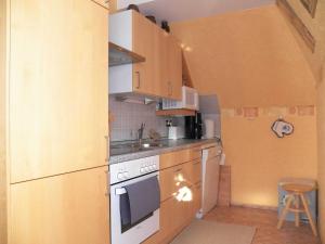 a small kitchen with a white stove top oven at Ferienwohnung Luise in Carolinensiel