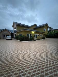 a house with a car parked in a driveway at Serene 2 bedroom fully furnished house in Haatso