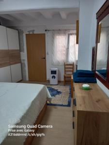 a bedroom with a bed and a table and a door at Casa De Giulio in Cocentaina