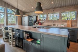 a kitchen with a large island with a counter top at Newly built house | Sauna | EV charger | Terrace in Lofsdalen
