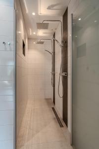 a bathroom with a shower with a glass door at Newly built house | Sauna | EV charger | Terrace in Lofsdalen +19 photos