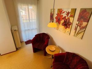 a living room with two chairs and a table at Deichgräfin 4 in Horumersiel +8 photos